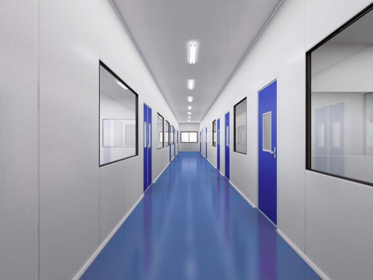 Corredor técnico do laboratório, com piso azul e salas de análise envidraçadas